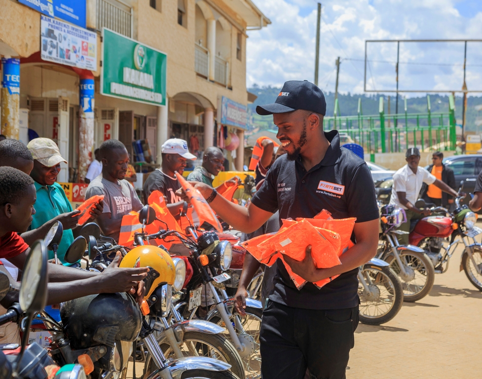 Muhangi handing over reflector jackets to bodaboda riders