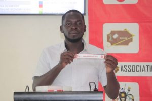 Draw assistant Solomon Walusimbi during the draw